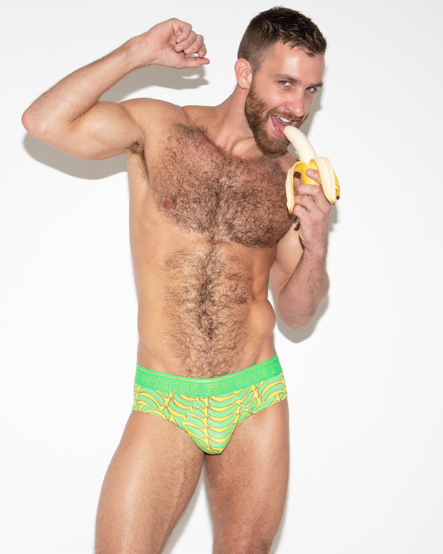 Sexy gay man eating a banana in underwear brand by Garcon print fun underwear